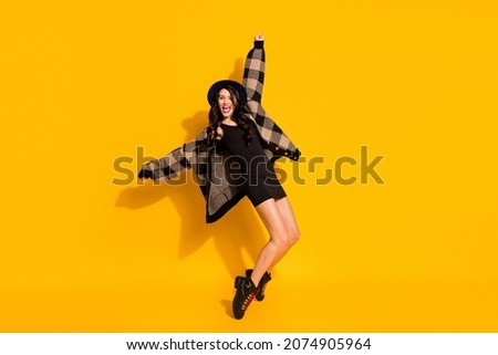 Photo of crazy energetic lady dance stand tiptoe wear hat plaid coat mini dress boots isolated yellow color background