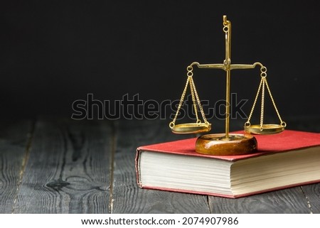 Legal Law and Justice concept - Open law book with a wooden judges gavel on table in a courtroom or law enforcement office. Copy space for text