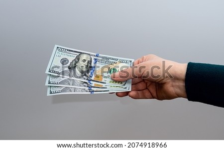 Female hand holding 100 Dollar bills. Financial business concept.