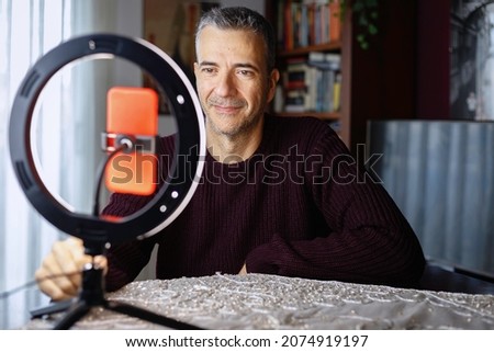 
Male influencer vlogging via mobile phone with light ring at home.
Conceptual of technology, people, lifestyle Royalty-Free Stock Photo #2074919197