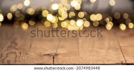 empty wooden table top with blurred light gold bokeh abstract background. For montage product display or design key visual layout