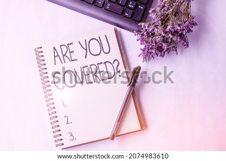 Sign displaying Are You Covered Question. Business overview asking showing if they had insurance in work or life Empty Opened Journal With A Pen Beside A Keyboard And A Flower On Desk.