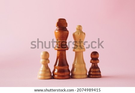 Family made with chess pieces on pastel background. Minimal concept.