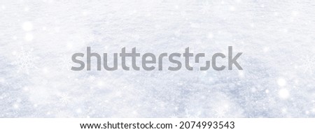 Winter sun and falling snow. Merry Christmas and Happy New Year background with snowflakes and texture of fresh, clean, sparkling, freshly fallen snow. Xmas design for advertising and season greetings Royalty-Free Stock Photo #2074993543