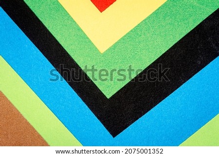 Multicolor background from a paper of different colors. Abstract colorful vibrant paper textures.