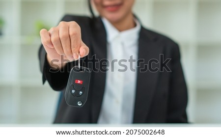 Sale agent giving Car key to customer and sign agreement contract, Insurance car concept