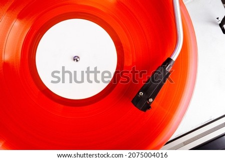 Close up of vintage turntable record player with red vinyl Royalty-Free Stock Photo #2075004016