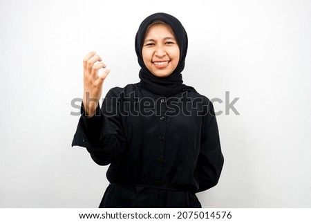 Beautiful young asian muslim woman upset, angry, dissatisfied, displeased, hateful, looking at camera isolated on white background