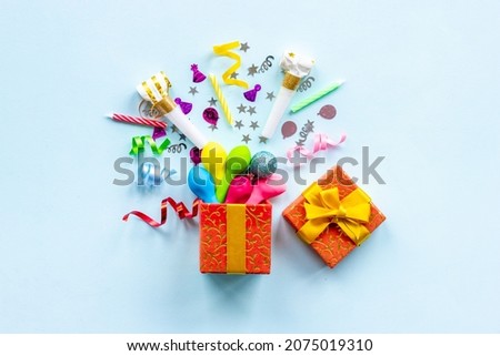 Gift box with party colorful decor flat lay top view
