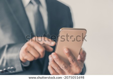 Business man using touchscreen smartphone with connection online communication selective focus