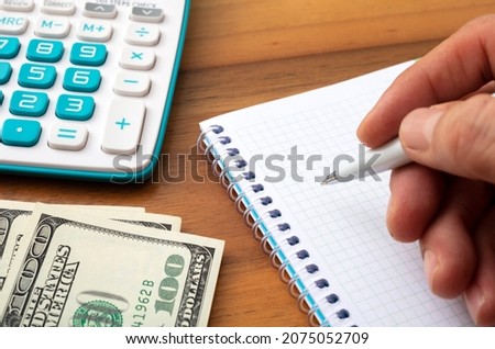 Calculator and US dollar bill banknotes