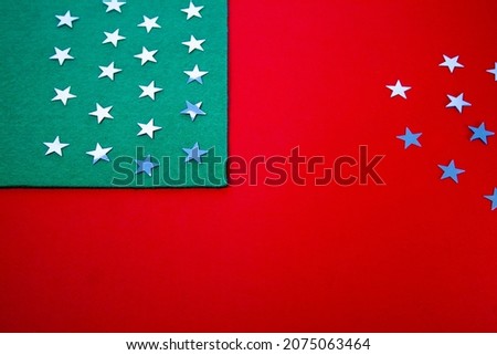 Christmas stars on a green background with red and white stripes in the form of an American flag.