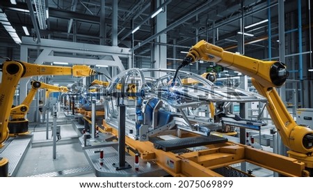 Car Factory 3D Concept: Automated Robot Arm Assembly Line Manufacturing High-Tech Green Energy Electric Vehicles. Automatic Construction, Building, Welding Industrial Production Conveyor. Royalty-Free Stock Photo #2075069899
