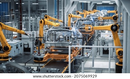 Car Factory 3D Concept: Automated Robot Arm Assembly Line Manufacturing Advanced High-Tech Green Energy Electric Vehicles. Construction, Building, Welding Industrial Production Conveyor. Back View Royalty-Free Stock Photo #2075069929
