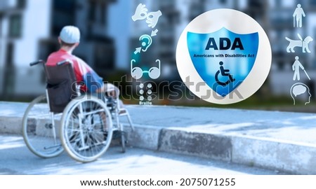 ADA Americans with Disabilities Act. Disabled man in a wheelchair in the city. High quality photo Royalty-Free Stock Photo #2075071255