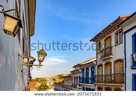 Historic city of Ouro Preto in Minas Gerais with its colonial architecture houses, lanterns and a church in the background Royalty-Free Stock Photo #2075071831