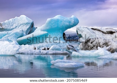 Beautiful blue icebergs reflected in the Jokulsarlon glacial lagoon, Southern Iceland. Part of the Vatnajokull National Park and Vatnajokull glacier, the largest glacier in Europe. Royalty-Free Stock Photo #2075085469