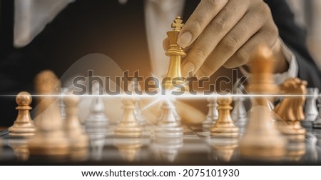 Person holding a chess piece against another opponent's chess, conceptual image of businessman playing chessboard compared to managing a business on risk, chart graphics showing financial flows.