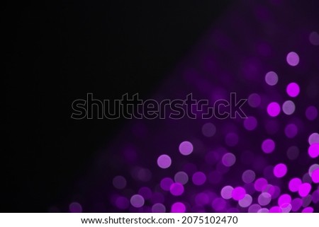 Beautiful frame of purple Bokeh light on black Background. Header Holiday Background. Template for Design flyer to New Year, Christmas Holiday, anniversary, birthday