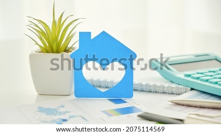Real Estate Concept Paper model house with keys against white blue print. Ecological building. Top view.