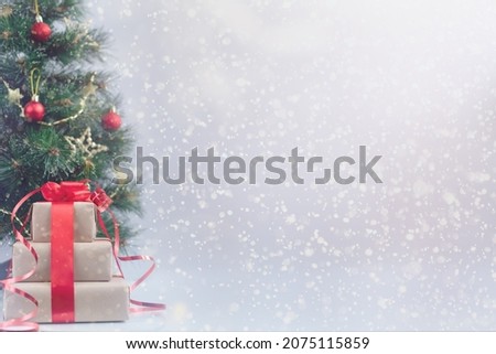 Blurred Christmas tree and gift boxes. Light festive background. Space for design and text. Holidays, celebration and presents concept.