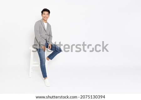 Happy young Asian startup businessman standing and smiling in white studio isolated background, Full body composition Royalty-Free Stock Photo #2075130394
