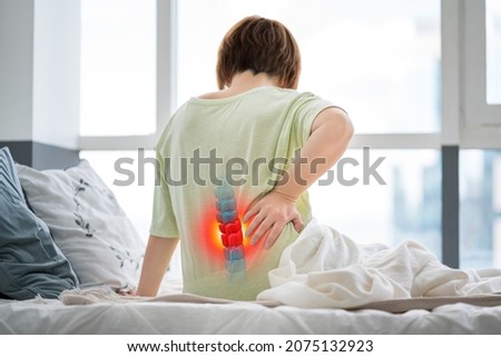Lumbar intervertebral spine hernia, woman with back pain at home, spinal disc disease, health problems concept Royalty-Free Stock Photo #2075132923