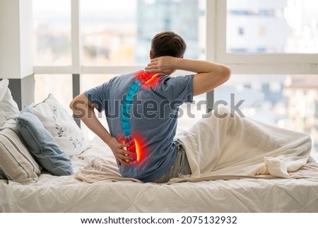Intervertebral hernia, neck and lumbar pain, man suffering from backache at home, spinal disc disease, health problems concept Royalty-Free Stock Photo #2075132932
