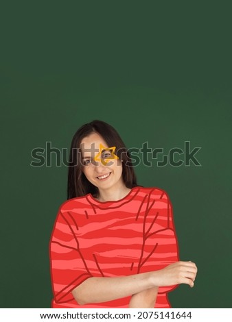 Holiday atmosphere. Contemporary art collage of beautiful young woman wearing red drawn sweater isolated on green background. Concept of winter holiday, Christmas, New Year, artwork. Copy space for ad