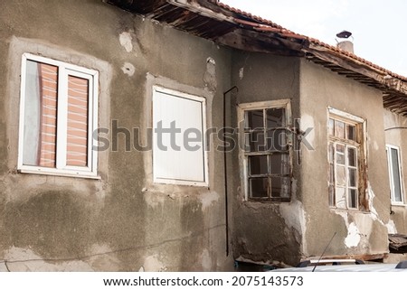 Old crumbling buildings and crumbling hillsides in the slums of Ankara, Turkey. Poor neighborhoods and unsanitary in the capital of Turkey. Living conditions Royalty-Free Stock Photo #2075143573