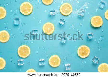 Lemon slices and ice cubes on a bright blue background, Contemporary food and drink refreshment summer vibes flat lay Royalty-Free Stock Photo #2075182552