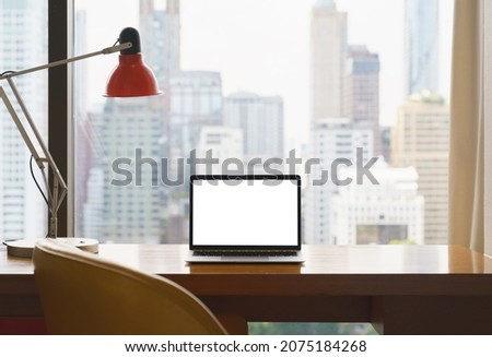 laptop white screen display on workspace see through city blur background Royalty-Free Stock Photo #2075184268