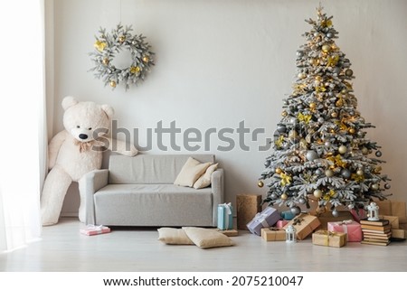 Christmas tree with gifts lights garlands teddy bear