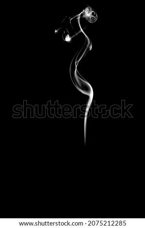 White smoke on black background. Vertical monochrome, grayscale photography of illuminated incense. Moody feeling. Dark backdrop, graphic resource for montage, overlay or texture, copy space.