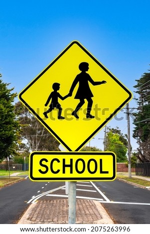 Children crossing road sign next to the school. 