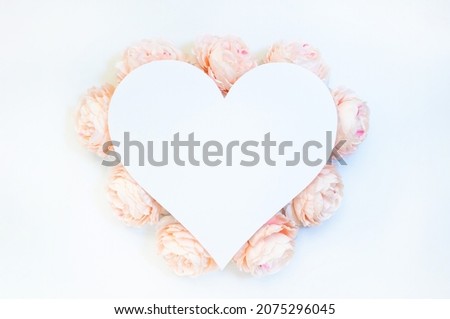 Flowers composition from pink flowers in the form of a heart on white background. Spring, summer template for your projects