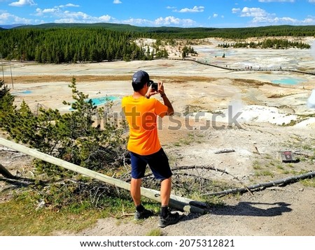 Photographer Capturing Beautiful Yellowstone Landscape on Summer Vacation