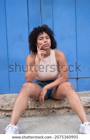 beautiful multiracial woman sitting in the street