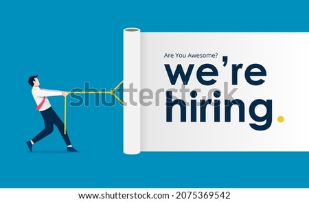 Businessman  pulling white curtain with the text we are hiring. Business recruiting design concept. Royalty-Free Stock Photo #2075369542