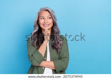 Photo of thinking aged grey hairdo lady look empty space wear khaki shirt isolated on blue color background Royalty-Free Stock Photo #2075374945