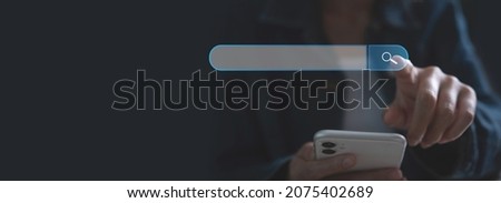 SEO Search Engine Optimization, online Internet browsing web, digital content concept. Woman using mobile phone with search bar magnifying glass graphic on virtual screen, banner Royalty-Free Stock Photo #2075402689