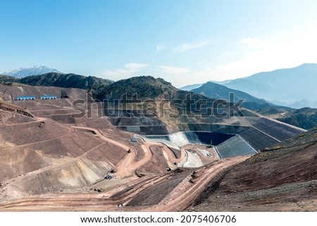 View of the industrial mine waste dam (tailing dam). A tailings dam is typically an earth-fill embankment dam used to store byproducts of mining operations after separating the ore from the gangue. Royalty-Free Stock Photo #2075406706
