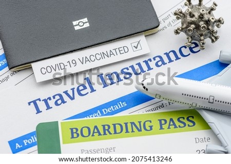 Travel insurance concept : Top view of travel insurance application form, a boarding pass, a passport, vaccine attestation, a plane. Travel insurance covers costs and losses associated with traveling Royalty-Free Stock Photo #2075413246