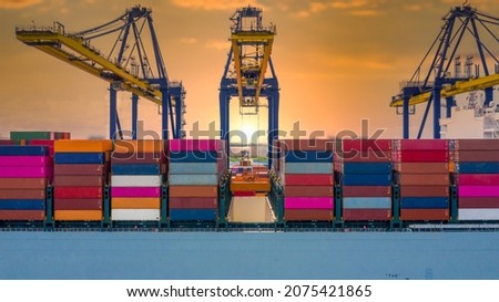 Industrial container logistics unloading import and export container terminal, Container ship carrying container with quay crane, Global business cargo freight shipping logistic oversea worldwide. Royalty-Free Stock Photo #2075421865