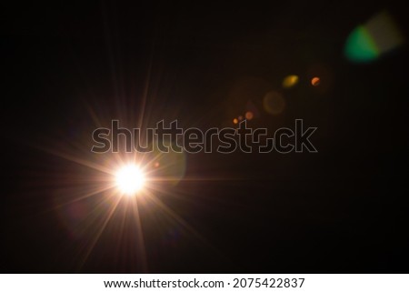 Sun flare on the black background Royalty-Free Stock Photo #2075422837