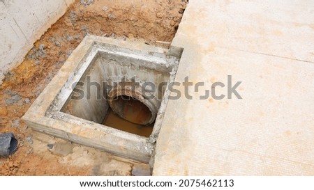 Sewer holes on the side of the road. manholes and concrete culverts beside roads to drain construction sites with copy spaces. Selective focus