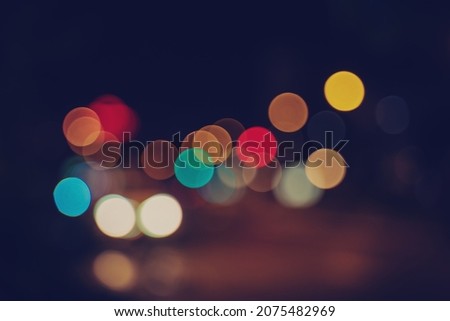 Bright colored bokeh glare on dark background, festive christmas new year background