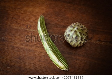Tropical and local green fruits on wooden brown table, isolated, top view and close up looking on fruits. selective focus. Local food called ''Cherimoya''