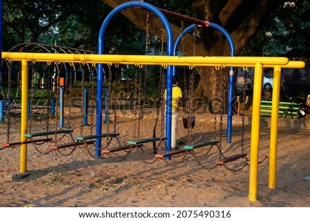 Stock photo of yellow and blue color painted climbing adventure equipment for kids, Picture captured at Rankala lake Kolhapur , Maharashtra, India. amusement concept. childhood memories.