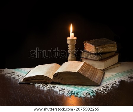 Grunge age dirty rough rustic brown psalm pray torah law letter archiv stack dark black wooden desk table space. New jew culture god Jesus Christ gospel literary art wood still life flame fire concept Royalty-Free Stock Photo #2075502265